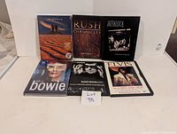 Group photo of 6 music DVDs including Led Zeppelin, Rush, Metallica, David Bowie, Black Sabbath, Elvis Presley