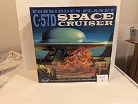 Front of the model kit box showing the Forbidden Planet C-57D Space Cruiser artwork, title and brand information.