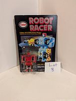 Front view of the vintage Esso Robot Racer transformer figure in blister card packaging showing the figure inside and the card artwork.