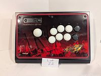 Front view of Street Fighter IV FightStick controller showing joystick, buttons, and artwork