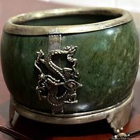Close-up view of the green jade censer showing silver dragon mount and footed base.