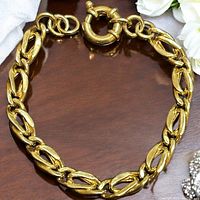 Gold over sterling silver 925 link bracelet laid flat showing full design and round spring clasp.