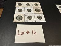 Coins in cardboard holders showing dates, conditions and denominations from late 1700s to early 1900s Annam (Vietnam) coins.