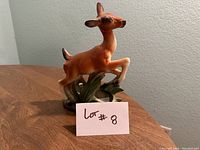 Photo of vintage ceramic fawn planter showing front and side profiles on a wooden surface.