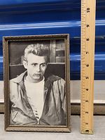 Framed black and white photo print of James Dean with a ruler next to it showing size approximately 8 inches high and 5 inches wide.