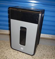 Full view photo of the black and gray TruRed paper shredder showing front and side design and overall size.