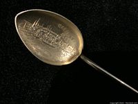 Close-up image of the vintage sterling silver spoon bowl showing engraved Halifax city skyline and hallmarked silver surface