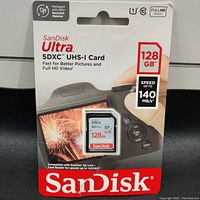 Photo of SanDisk Ultra 128GB SDXC UHS-I SD memory card in original retail packaging showing all key specifications including 140 MB/s speed, Class 10 and Full HD video support.