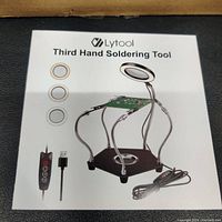 Boxed Lytool Third Hand Soldering Tool packaging showing the product and features including LED ring light color options and USB controller.