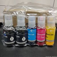 Five bottles of sublimation printer ink, including two black, one cyan, one magenta, and one yellow bottle with nozzle caps, shrink-wrapped.