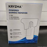 Front of the Kryzma powered earwax remover box with product features: pro, rechargeable, easy operation; on/off button; 3 pressure settings; LED indicators.
