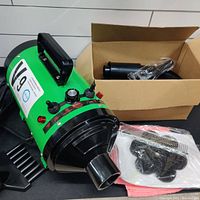 Green PetLife V-9 pet dryer showing overall unit, black handle on top, front nozzle, and control switches.