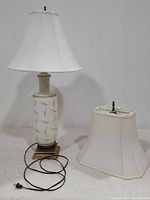 Full view of vintage glass lamp with attached white shade and extra shade beside it, showing lamp body, cord, and plug.