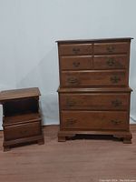Chest of drawers and nightstand set shown together, both made of maple with brass hardware.