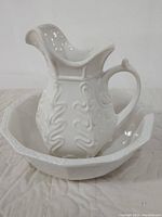 Pitcher resting inside the bowl showing the overall size and matching design