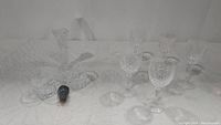 Group photo of the crystal and glassware items including vases and glasses on a white surface.