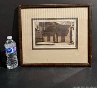 Framed original aquatint print next to a water bottle for scale.