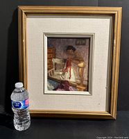 Framed painting with water bottle for scale