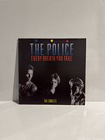 Front cover of The Police Every Breath You Take The Singles LP, showing band members and title.