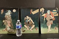 Triptych of three Japanese woodblock prints showing traditional figures next to a water bottle for scale.