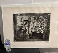 Full view of unframed black and white art print next to a water bottle showing size scale, protected in shrink wrap.
