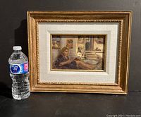 Full view of framed painting with water bottle for scale