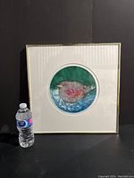 Framed "Tatoria" bird print with water bottle for size context