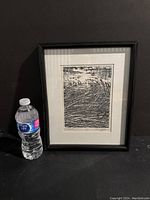 Framed black and white marsh scene print next to a water bottle for size reference. The print is approximately 9x6 inches.
