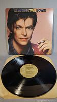 Full view of David Bowie album cover 'ChangesTwoBowie' with vinyl record in inner sleeve placed in front.