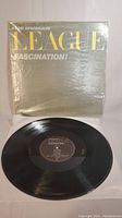 Vinyl record and its outer sleeve showing the album cover titled 'Fascination' by The Human League.