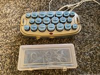 Top view of Conair heated hair curler set with 20 blue rollers and plastic clip storage.
