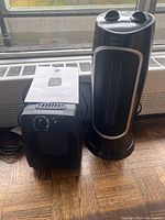 Photo showing Noma floor heater and Likewise ceramic heater side by side with a window background