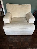 Front view of cream pinstripe armchair
