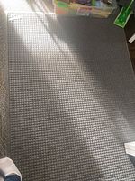 Photo of full gray textured Waterhog area rug showing waffle-like pattern and rectangular shape.