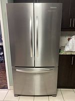 Front view of stainless steel French door refrigerator with bottom freezer drawer