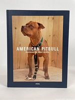 Front cover of the American Pitbull photography book by Marc Joseph showing the dog against a wooden wall background.
