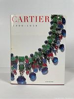 Front cover of Cartier 1900-1939 by Judy Rudoe featuring a large colorful necklace design on a white background.