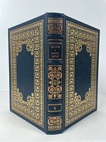 Front and back cover showing full leather with ornate gold gilt floral decoration and spine title.