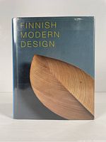 Front cover of Finnish Modern Design book with wooden design and text on dust jacket