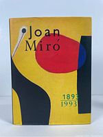 Front cover of Joan Miro: 1893-1993 book showing abstract colorful art on yellow background.