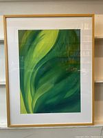 Framed watercolor painting showing abstract green and yellow foliage design.