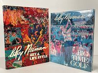Two large hardcover art books displayed upright, 'Art & Life Style' and 'Big Time Golf' by Leroy Neiman, showing colorful covers with human figures and action scenes.