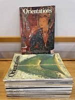 Front view showing two magazine covers from the lot, one with an Asian painting of a woman and the other with a landscape, illustrating the artistic focus of the Orientations publications.