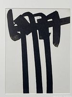 Unframed view of lithograph showing abstract black brushstroke forms on white paper