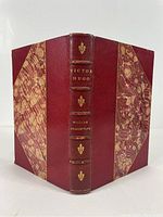 Front cover and spine of the book showing half red Morocco leather binding with marbled covers and gold embossing on spine.