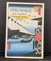 Front cover of the hardcover art book showing a colorful woodblock print scene on the dust jacket.