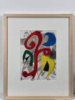 Full view of framed lithograph showing light wood frame, white mat and abstract print