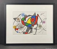 Framed lithograph front view showing entire black wood frame with white mat