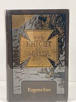 Front cover showing the title, author, and illustrated design with gold embossing.