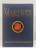 Front cover of 'The Marines' book showing the title, Marine Corps emblem and publisher information.